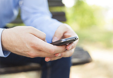 a gentleman is using mobile phone, enjoying SC mobile wallets benefits