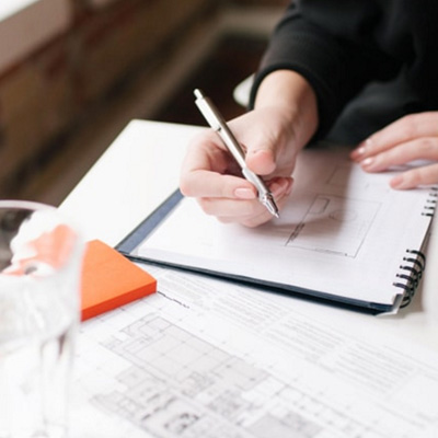 A hand holding a pen to fill in a form