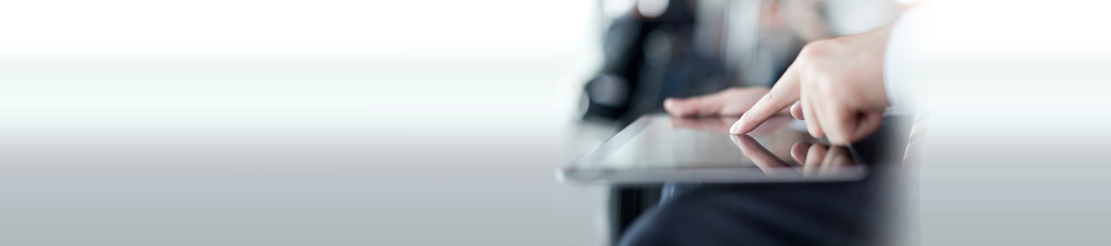 a gentleman tapping on a tablet with his finger