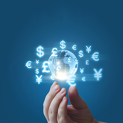 one hand holding the earth model with different currency icons