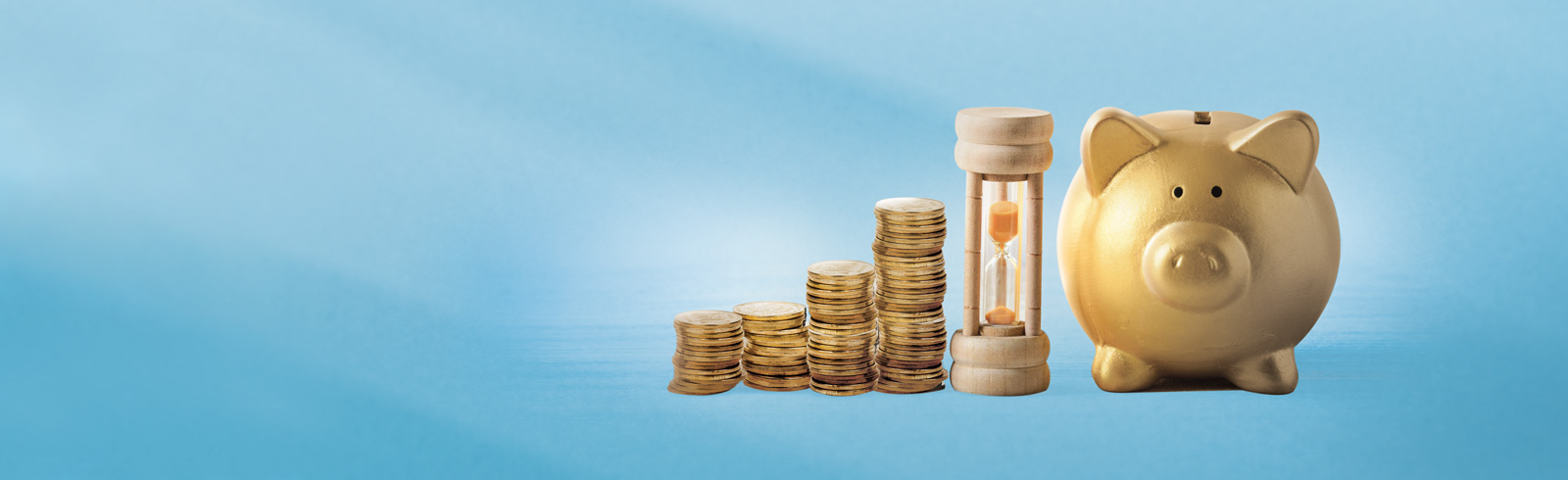 an hourglass in between of a piggy bank and stacks of coins