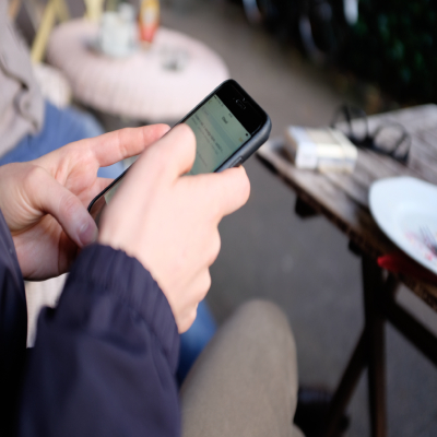 a gentleman using his mobile phone to enjoy mobile services from Standard Chartered